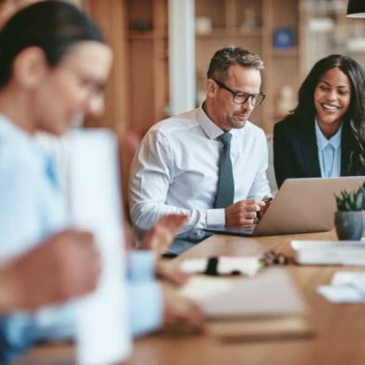 Office with young professional sat in a meeting