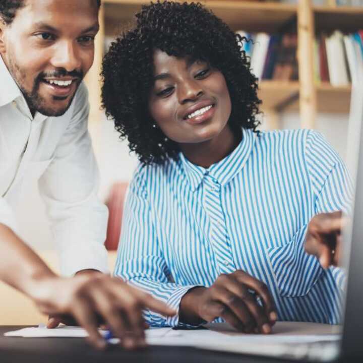 Members of a HR team discussing Employee Engagement at a desk