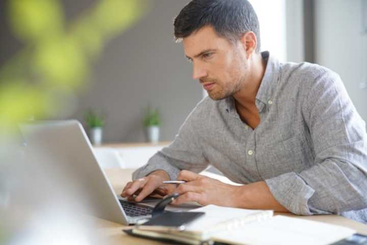 Middle-aged man working from home on laptop