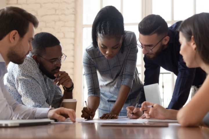 A group of young business people discussing a project