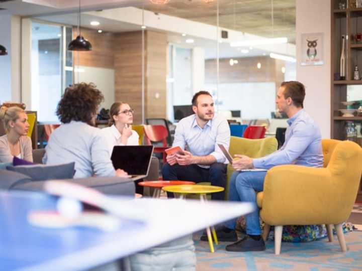 Mixed group of employees having a discussion in a modern office