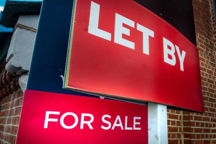 Estate agent For Sale and Let By signs on street of houses