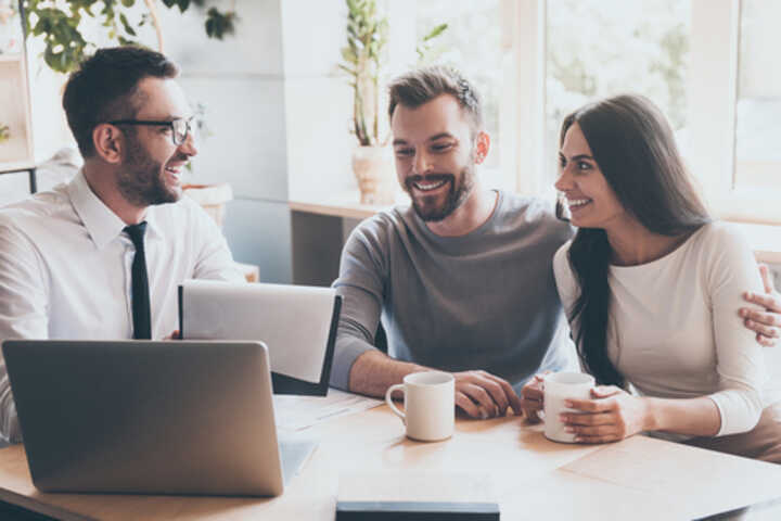 Adviser and young couple agreeing a new mortgage deal