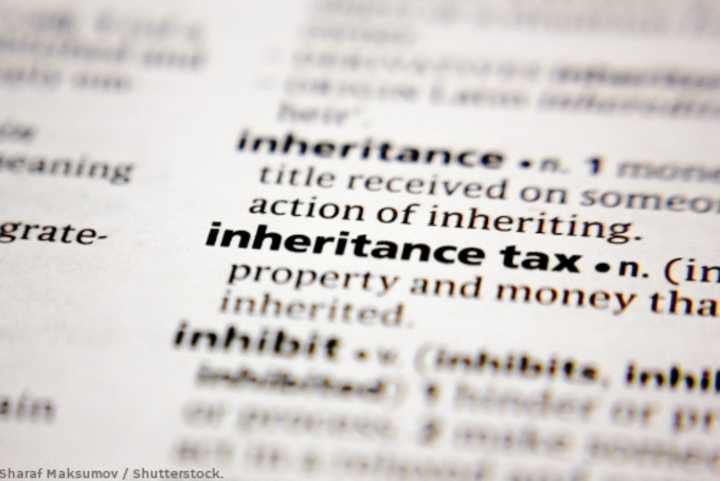 Close-up view of the phrase 'inheritance tax' in a dictionary