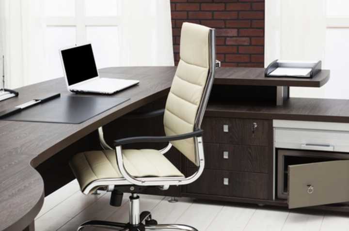 Empty office chair at a desk with a laptop