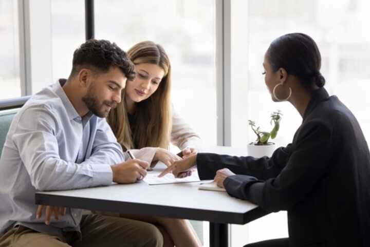 Young couple signing a mortgage agreement