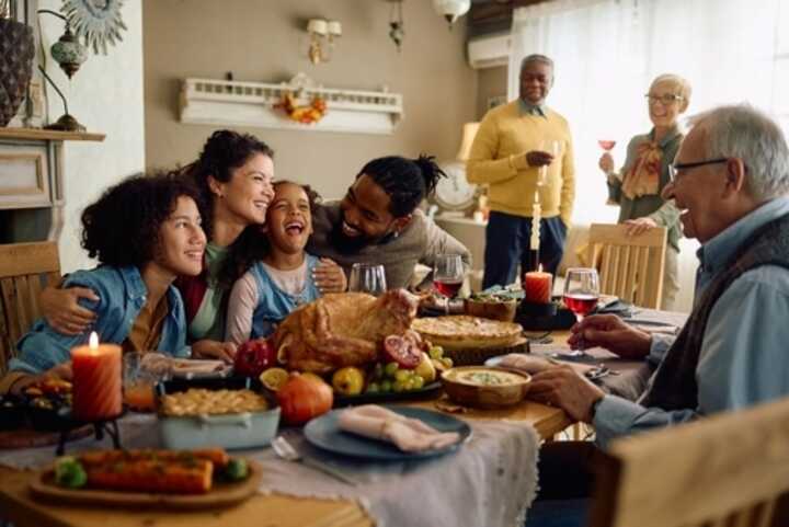 Three generations of a family enjoying a meal together